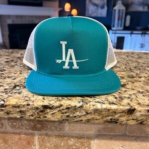 Women’s ValSurf 1962 label LA hat. Adjustable white mesh with teal blue